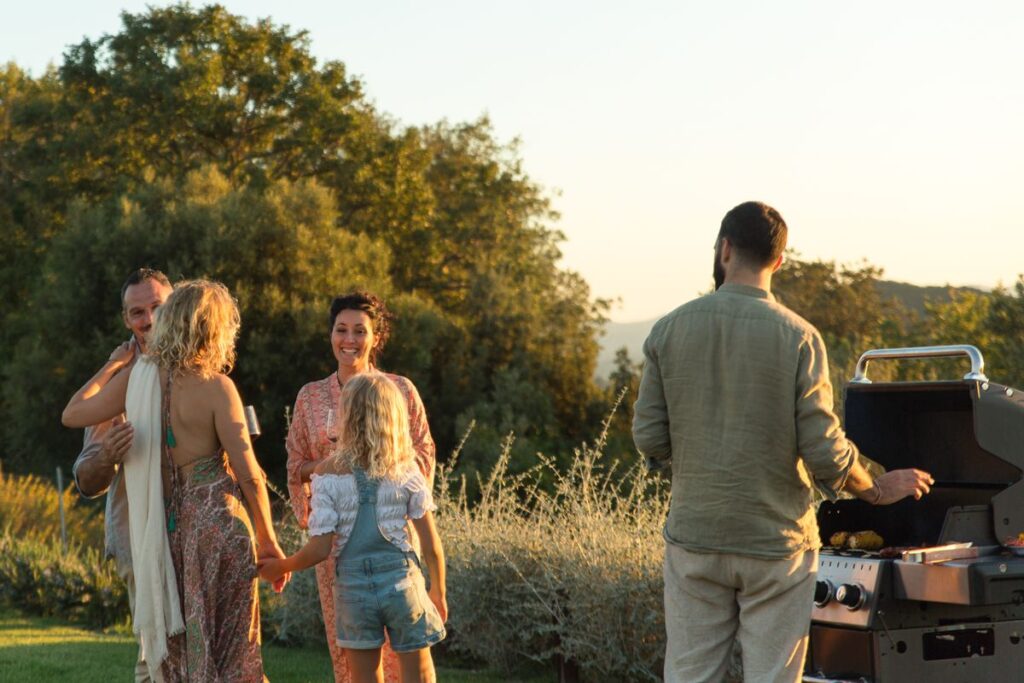 Outdoor family at villa, Family enjoying  summer BBQ at luxury villa in Tuscany, Italy