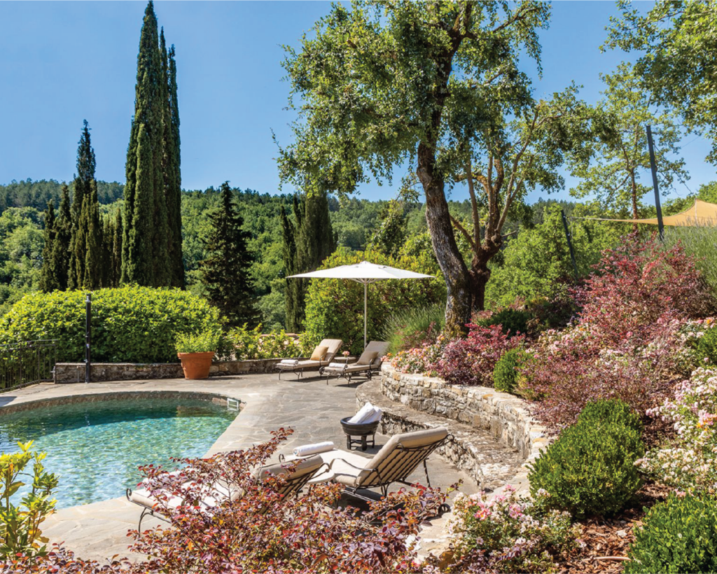 Luxury villa rental in Tuscany with panoramic views over the countryside of vineyards and olive groves.